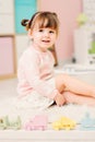 Cute happy 2 years old baby girl playing with toys at home Royalty Free Stock Photo