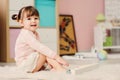 Cute happy 2 years old baby girl playing with toys at home Royalty Free Stock Photo