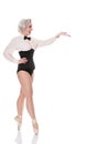 Cute happy young dancer in corset & bow tie, gestures towards