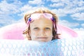 Little Girl Smiling in Inflatable Poll Royalty Free Stock Photo