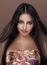 Cute happy young indian woman in studio close up