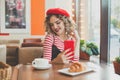 Cute happy young woman with smartphone in cafe Royalty Free Stock Photo