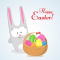 A cute hare a rabbit bunny and a basket with bright Easter eggs a symbol of the feast of Easter Decorative design element