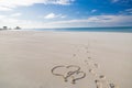 Heart shape drawing in the sand on tropical beach, romantic and honeymoon concept background for couples