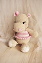 Cute Hippopotamus crochet in vintage background. Toy for kids. Hippo knitting. Handmade. Hippie soft toy Cute woolen. Hippie baby