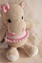 Cute Hippopotamus crochet in vintage background. Toy for kids. Hippo knitting. Handmade. Hippie soft toy Cute woolen. Hippie baby
