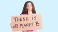 Cute hispanic child girl holding there is no planet b banner covering mouth with hand, shocked and afraid for mistake Royalty Free Stock Photo