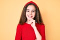 Cute hispanic child girl wearing casual clothes and diadem looking confident at the camera with smile with crossed arms and hand Royalty Free Stock Photo