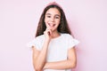 Cute hispanic child girl wearing casual clothes and diadem looking confident at the camera with smile with crossed arms and hand Royalty Free Stock Photo