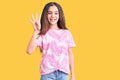 Cute hispanic child girl wearing casual clothes showing and pointing up with fingers number four while smiling confident and happy Royalty Free Stock Photo