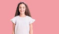 Cute hispanic child girl wearing casual white tshirt with a happy and cool smile on face Royalty Free Stock Photo