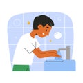 Cute hispanic preschool child, boy washes hands, uses soap, foam bubbles, rinses hands with water from faucet tap in the Royalty Free Stock Photo