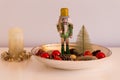 Cute holidays interior decoration with nutcracker soldier in golden bowl Royalty Free Stock Photo