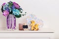 Cute home decor, a small black Board for notes, a place for text, two yellow textile bears and a bouquet of flowers in a vase Royalty Free Stock Photo