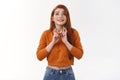 Cute hopeful redhead girl look up sky implore god wish come true smiling delighted faithfully praying cross fingers good