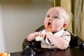 Cute hungry baby eating solid food Royalty Free Stock Photo