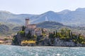 Idyllic coastline scenery in Italy, captured from the water. Blue water and a cute village at lago di garda, Malcesine