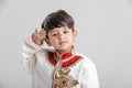 Cute Indian / Asian little boy in ethnic wear and Saluting national flag Royalty Free Stock Photo