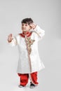 Cute Indian / Asian little boy in ethnic wear and Saluting national flag Royalty Free Stock Photo