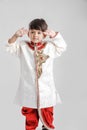 Cute Indian / Asian little boy in ethnic wear and Saluting national flag Royalty Free Stock Photo