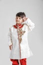 Cute Indian / Asian little boy in ethnic wear and Saluting national flag Royalty Free Stock Photo