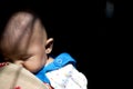 Cute Indian baby sleeping on her mother`s shoulder Royalty Free Stock Photo