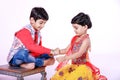 Cute Indian child brother and sister celebrating raksha bandhan festival , Royalty Free Stock Photo