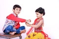 Cute Indian child brother and sister celebrating raksha bandhan festival , Royalty Free Stock Photo