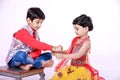 Cute Indian child brother and sister celebrating raksha bandhan festival , Royalty Free Stock Photo