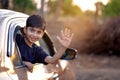 Cute Indian Child waving from car window Royalty Free Stock Photo