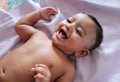 A cute indian innocent new born baby in a jovial mood with a charming smile