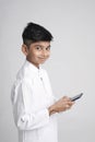 Cute Indian little boy using smart phone Royalty Free Stock Photo