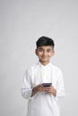 Cute Indian little boy using smart phone Royalty Free Stock Photo