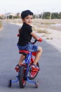Cute indian toddler riding a bicycle with smile