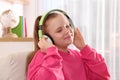 Cute indie girl in headphones listening music at home Royalty Free Stock Photo