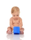 Cute infant child baby girl toddler sitting with blue toy brick Royalty Free Stock Photo