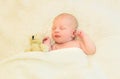 Cute infant sleeping together with teddy bear toy on bed home Royalty Free Stock Photo