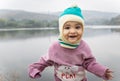 cute infant in winter dress and monkey cap innocent facial expression at morning