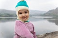 cute infant in winter dress and monkey cap innocent facial expression at morning