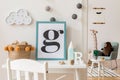 Cute interior of kid room with poster frame, baby accessories and toys. Royalty Free Stock Photo