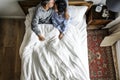 Cute interracial couple on the bed kissing Royalty Free Stock Photo