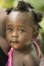 Cute Jamaican baby girl, wide brown eyes, Jamaica