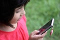 Cute Japanese-Russian girl playing with a cellphon Royalty Free Stock Photo