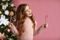 Cute joyful little child girl holding lollipop candy cane Royalty Free Stock Photo