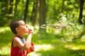 Cute kid blowing soap bubbles Royalty Free Stock Photo