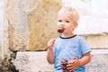 Child boy with Fritule - Croatian sweet pastry, cookies, homemade fritters Royalty Free Stock Photo