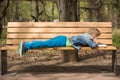 Cute kid boy lying on the bench in the park and reading a book on a sunny summer day. Child learning and reading. Education. Royalty Free Stock Photo