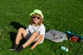 Cute kid boy relaxing on meadow. Happy child playing in summer park. Little boy resting in fresh spring grass. Happy