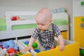 Cute kid or child playing colorful balls looking down Royalty Free Stock Photo