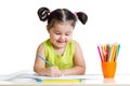 Cute kid drawing with colorful pencils and smiling Royalty Free Stock Photo